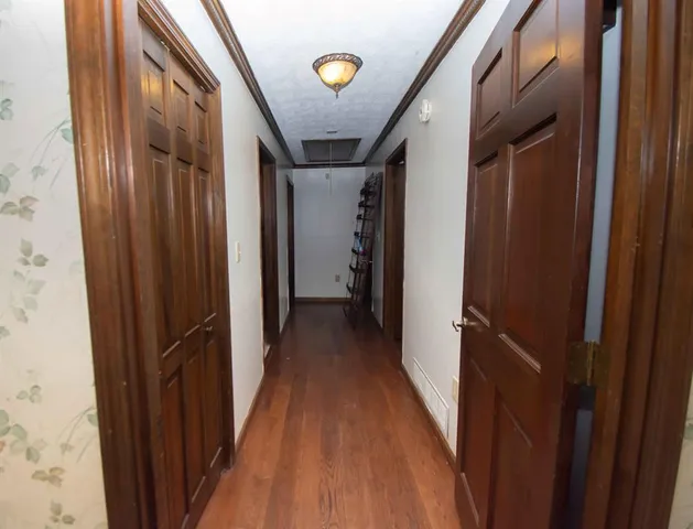 a view of empty room with wooden floor