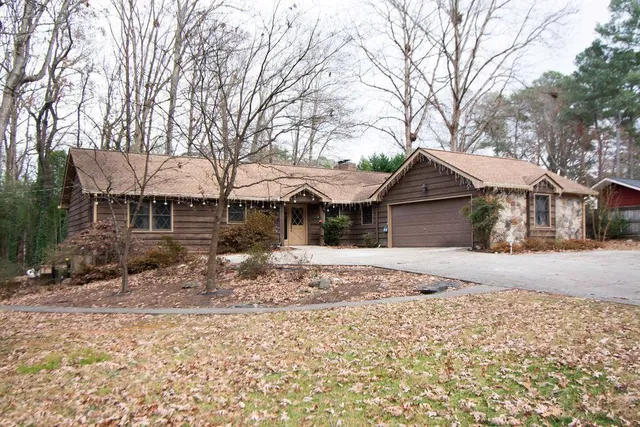 a view of a house with a yard covered in snow