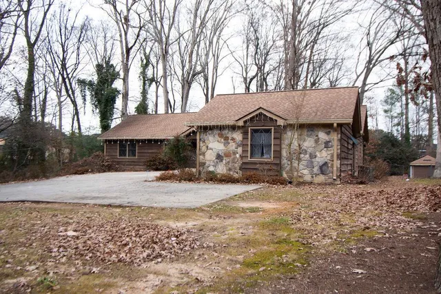 a front view of a house with a tree