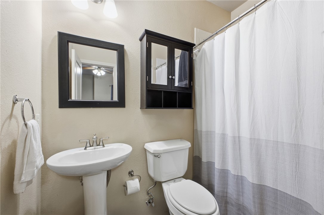 4400 Milam Street Bryan, TX 77801 - Photo 15 of 25 a bathroom with a toilet sink and mirror