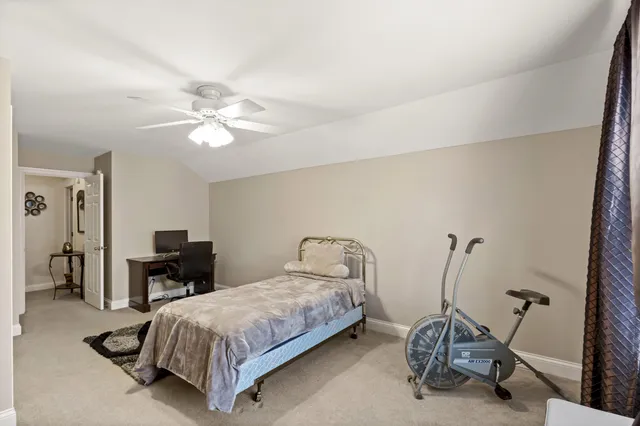 a bedroom with a bed a table and chair