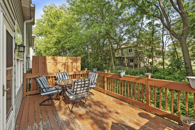 a view of balcony with wooden floor and outdoor seating