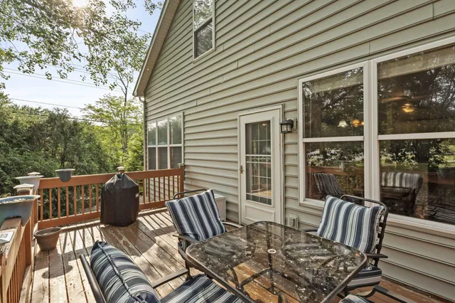 a view of balcony with wooden floor and outdoor seating