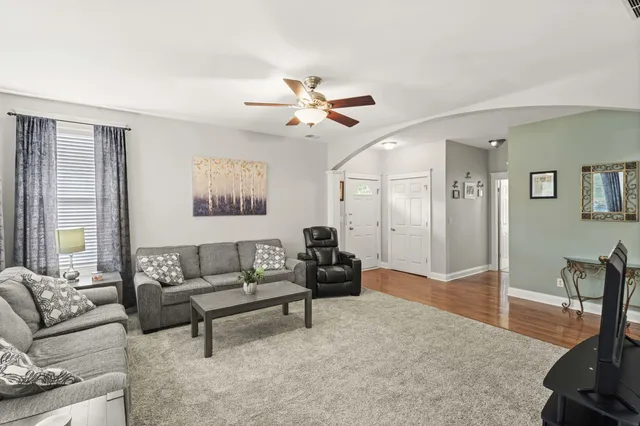 a living room with furniture and a chandelier