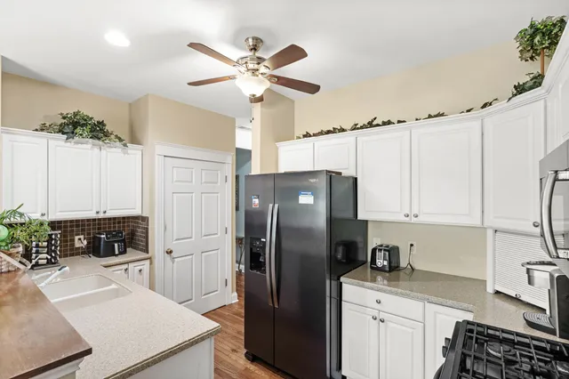 a kitchen with stainless steel appliances a refrigerator sink and stove