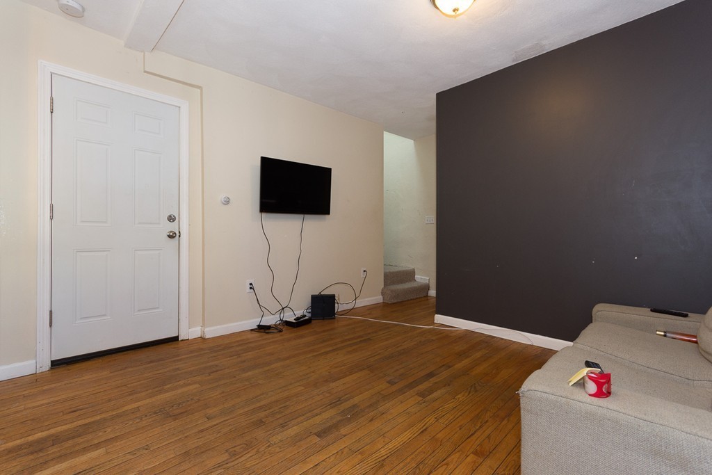 5 Everett Court Boston, MA 02128 - Photo 3 of 9 a view of a room with wooden floor and a flat screen tv