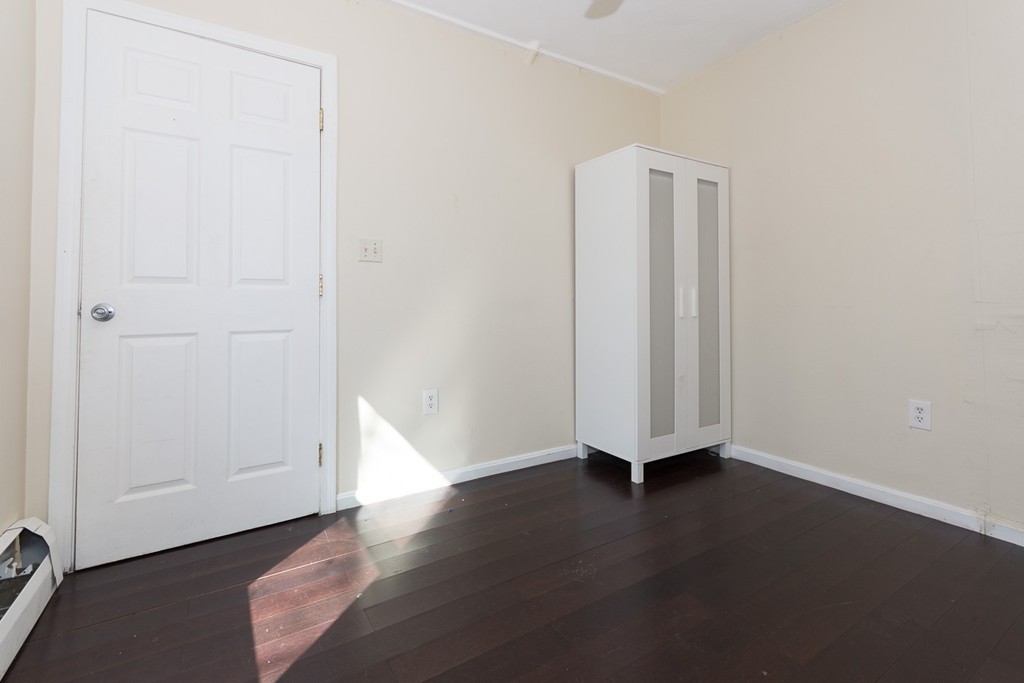5 Everett Court Boston, MA 02128 - Photo 4 of 9 an empty room with wooden floor and closet
