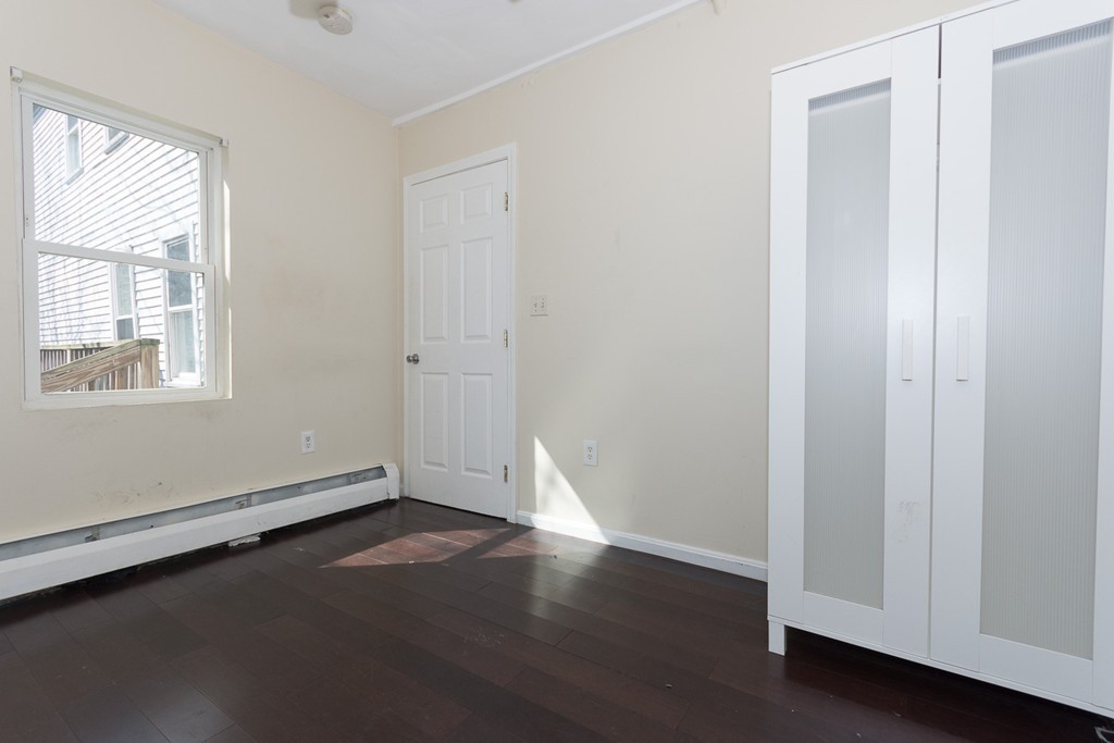 5 Everett Court Boston, MA 02128 - Photo 5 of 9 an empty room with wooden floor and windows