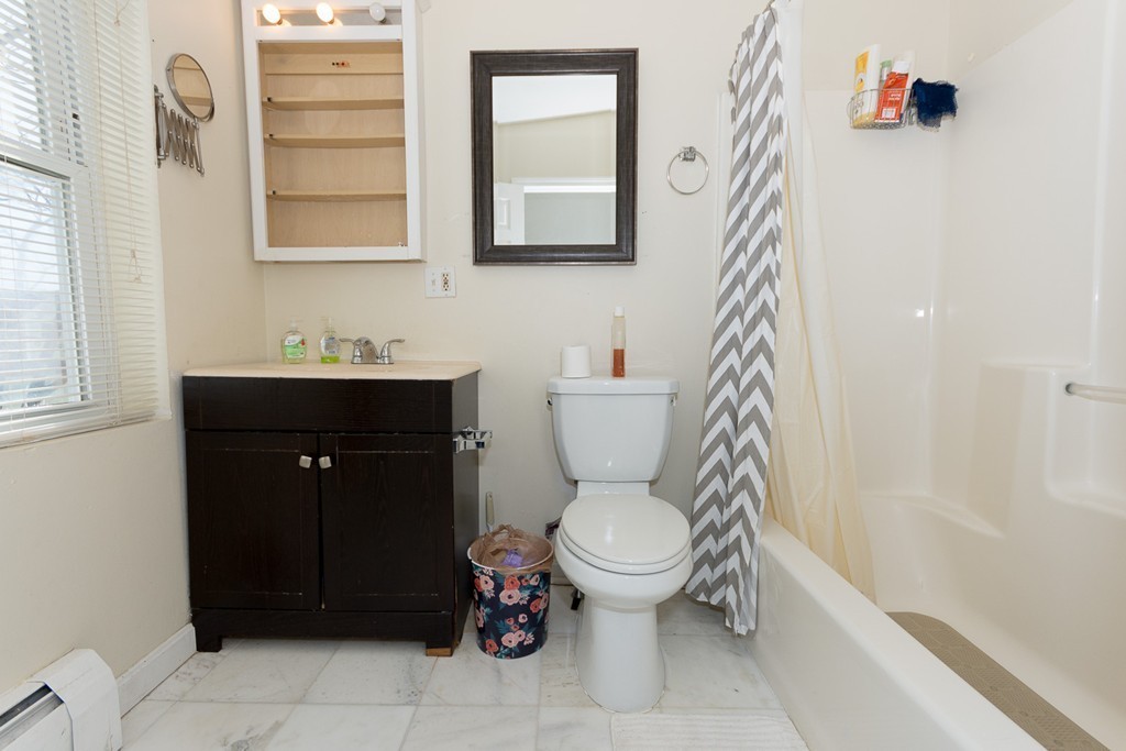 5 Everett Court Boston, MA 02128 - Photo 6 of 9 a bathroom with a toilet sink and mirror