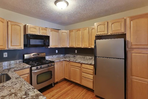 5 Everett Court Boston, MA 02128 - Photo 7 of 9 a kitchen with granite countertop a refrigerator stove and microwave