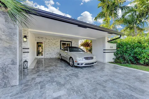 a bathroom with a granite countertop sink toilet and large mirror