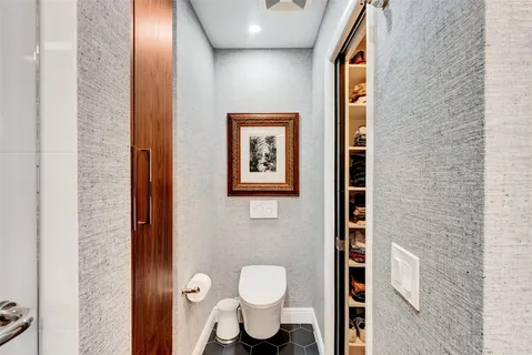 a yellow house with flower garden in front of it