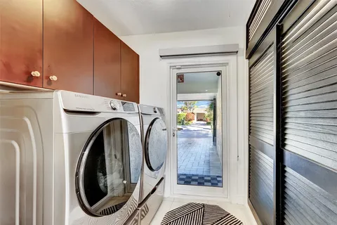 a view of living room kitchen and patio
