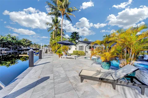 a living room with furniture a rug and white walls