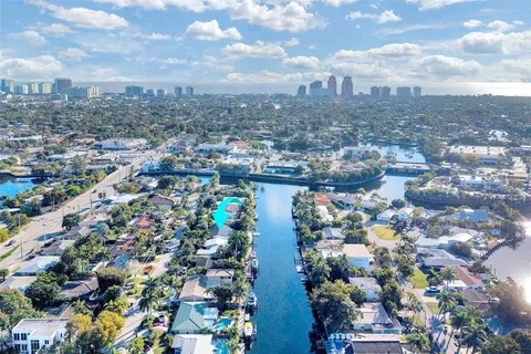 an aerial view of residential houses with outdoor space and swimming pool
