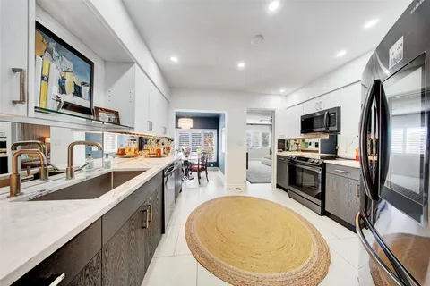 a front view of a house with palm trees