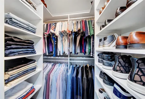 a view of a patio with table and chairs potted plants and floor to ceiling window