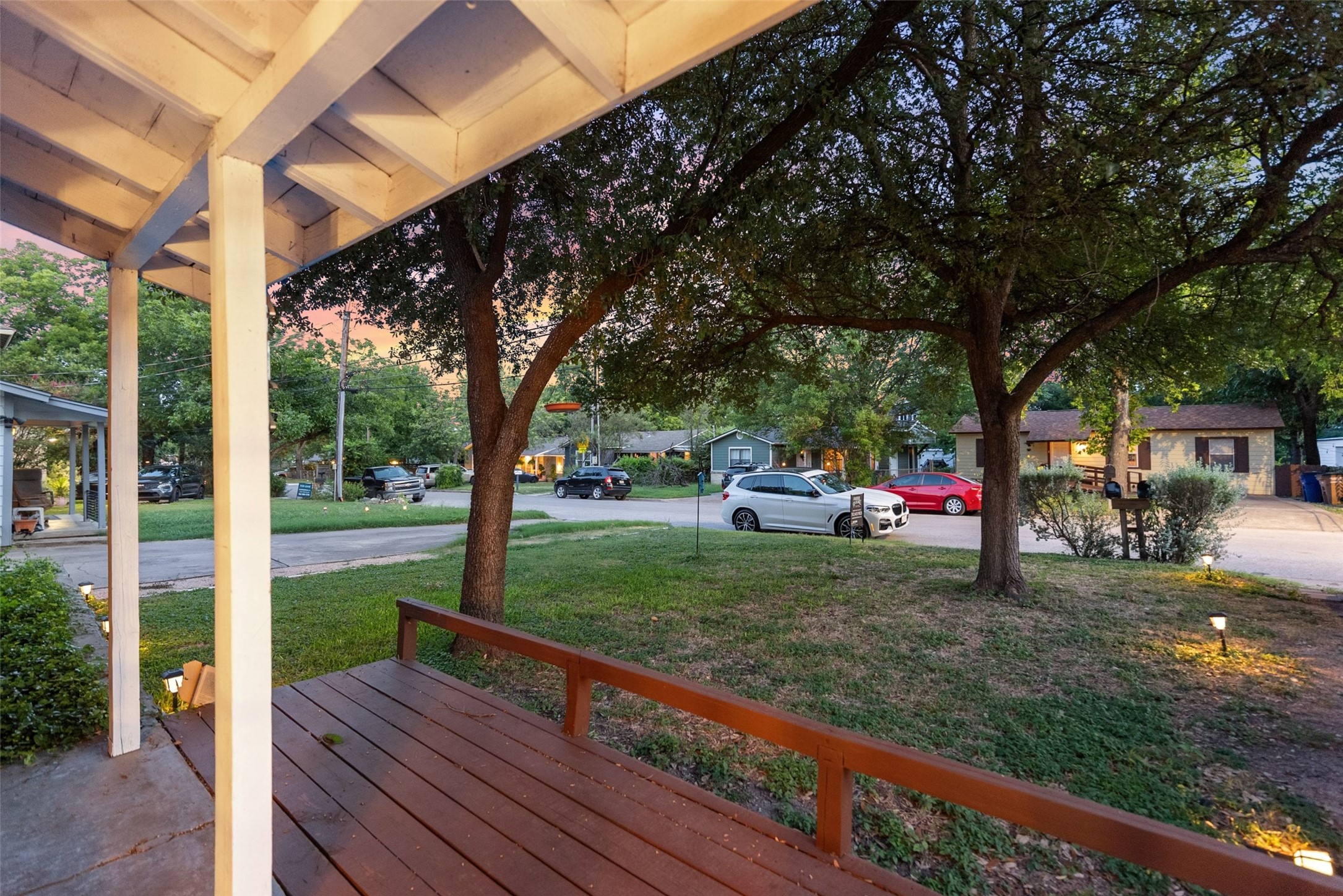 412 West Croslin Street Austin, TX 78752 - Photo 3 of 36 A welcoming front porch with mature trees offers a serene neighborhood outlook.