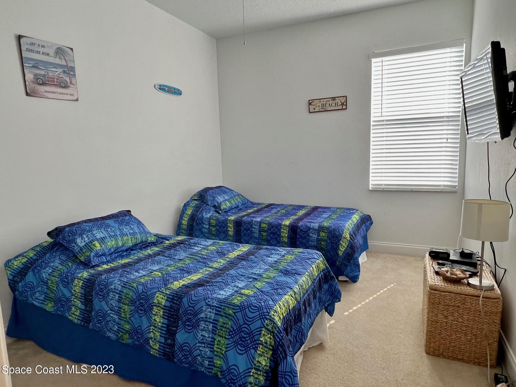 3193 Ricks Way Melbourne Beach, FL 32951 - Photo 12 of 22 a bedroom with two beds and a window