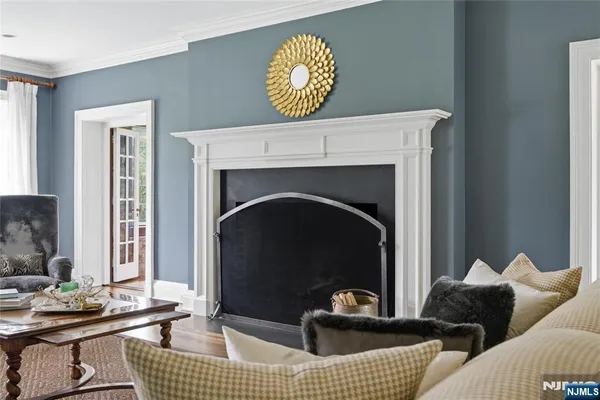 a living room with furniture a fireplace and a table