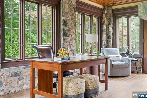 a living room with furniture and large windows
