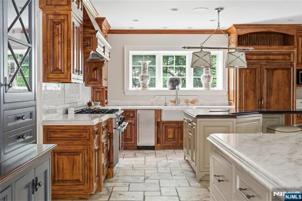 a kitchen with stainless steel appliances granite countertop a sink and a stove