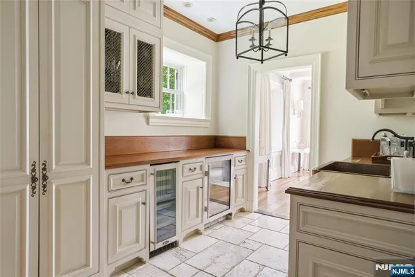 a kitchen with granite countertop a sink stove and cabinets