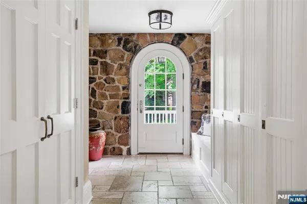 a view of a entryway door with a hallway
