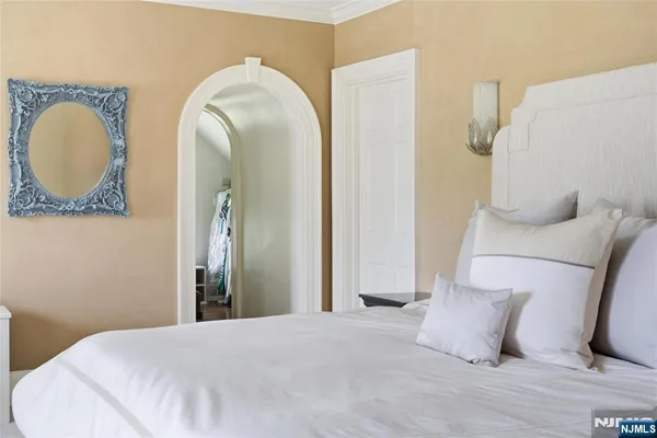 a bedroom with a bed and a mirror