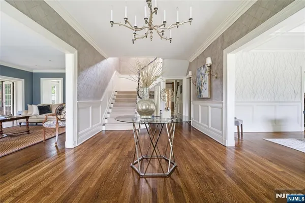 a view of a livingroom with furniture wooden floor chandelier