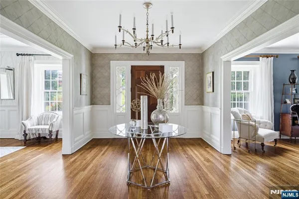 a view of a dining room with furniture wooden floor and chandelier
