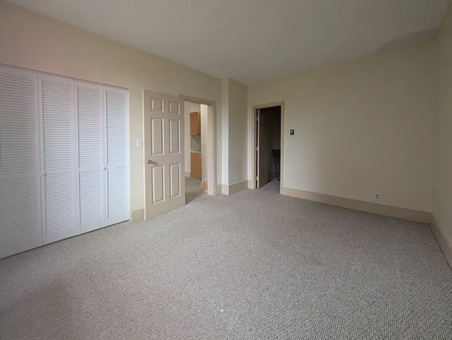 a view of an empty room and closet area