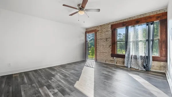 wooden floor in an empty room with a window
