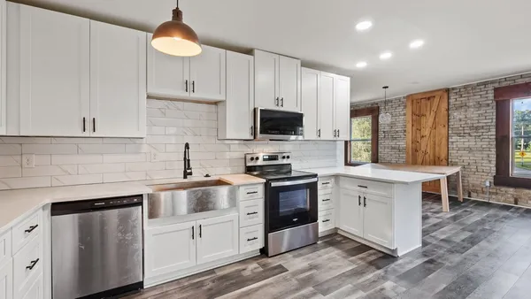 a kitchen with a sink stove and cabinets