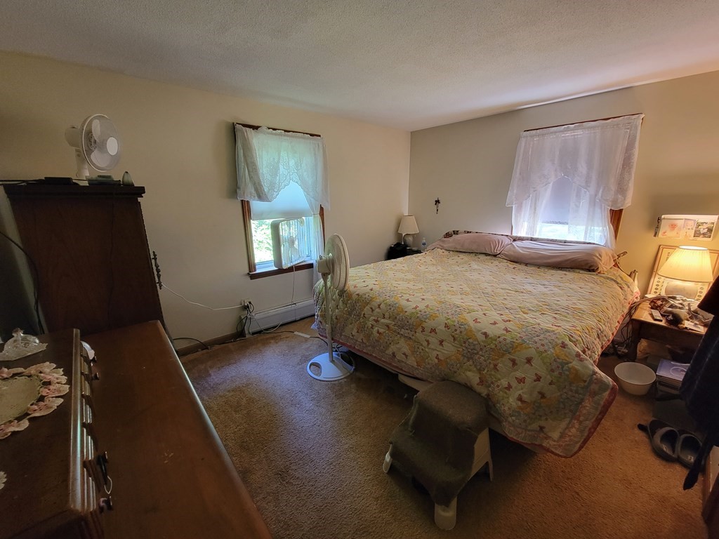 208 Old Belchertown Road Ware, MA 01082 - Photo 11 of 23 a bedroom with a bed closet and mirror