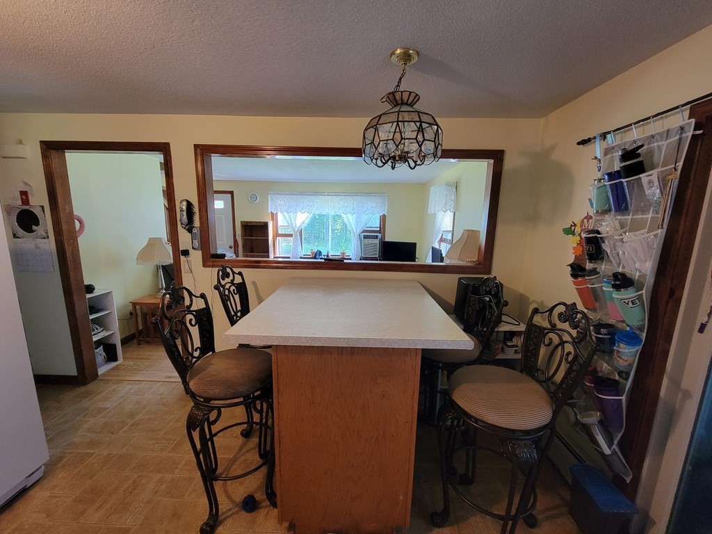 208 Old Belchertown Road Ware, MA 01082 - Photo 7 of 23 a view of a dining room with furniture a chandelier and wooden floor