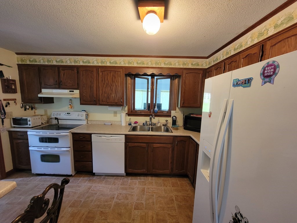 208 Old Belchertown Road Ware, MA 01082 - Photo 8 of 23 a kitchen with stainless steel appliances granite countertop a refrigerator sink and stove