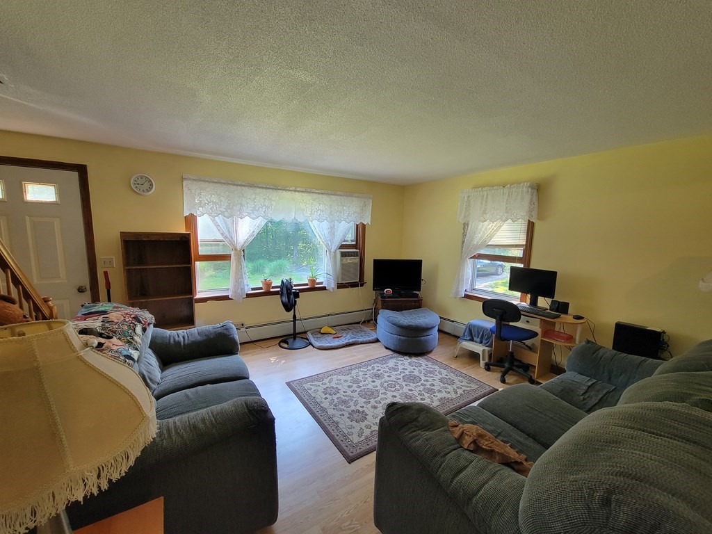 208 Old Belchertown Road Ware, MA 01082 - Photo 9 of 23 a living room with furniture and a flat screen tv