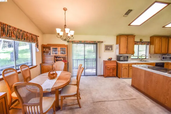a view of a dining room with furniture large windows and wooden floor