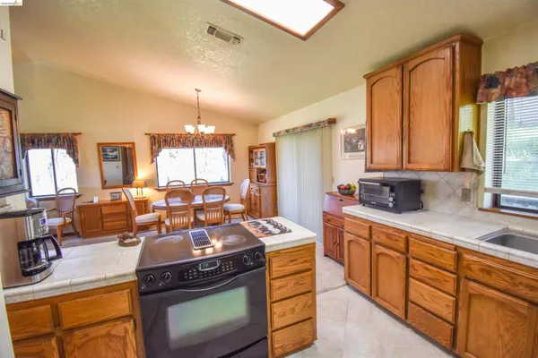 a kitchen with a stove a sink and a refrigerator