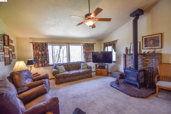 a living room with furniture a flat screen tv and a window