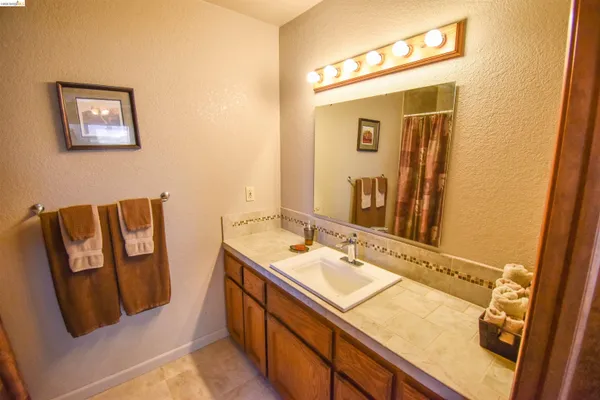 a bathroom with a sink mirror and vanity