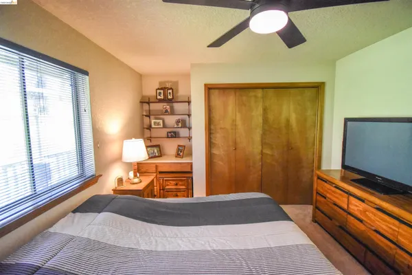 a bedroom with a bed and a flat tv screen