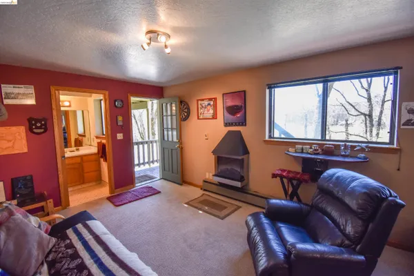 a living room with furniture a flat screen tv and large window