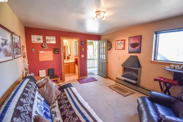 a bedroom with furniture and a flat screen tv