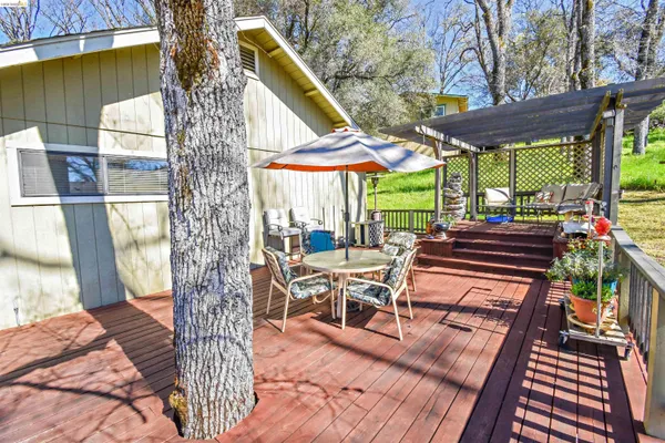 a view of a patio with a table chairs and a backyard