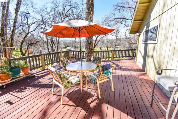 a view of a balcony with furniture and umbrella