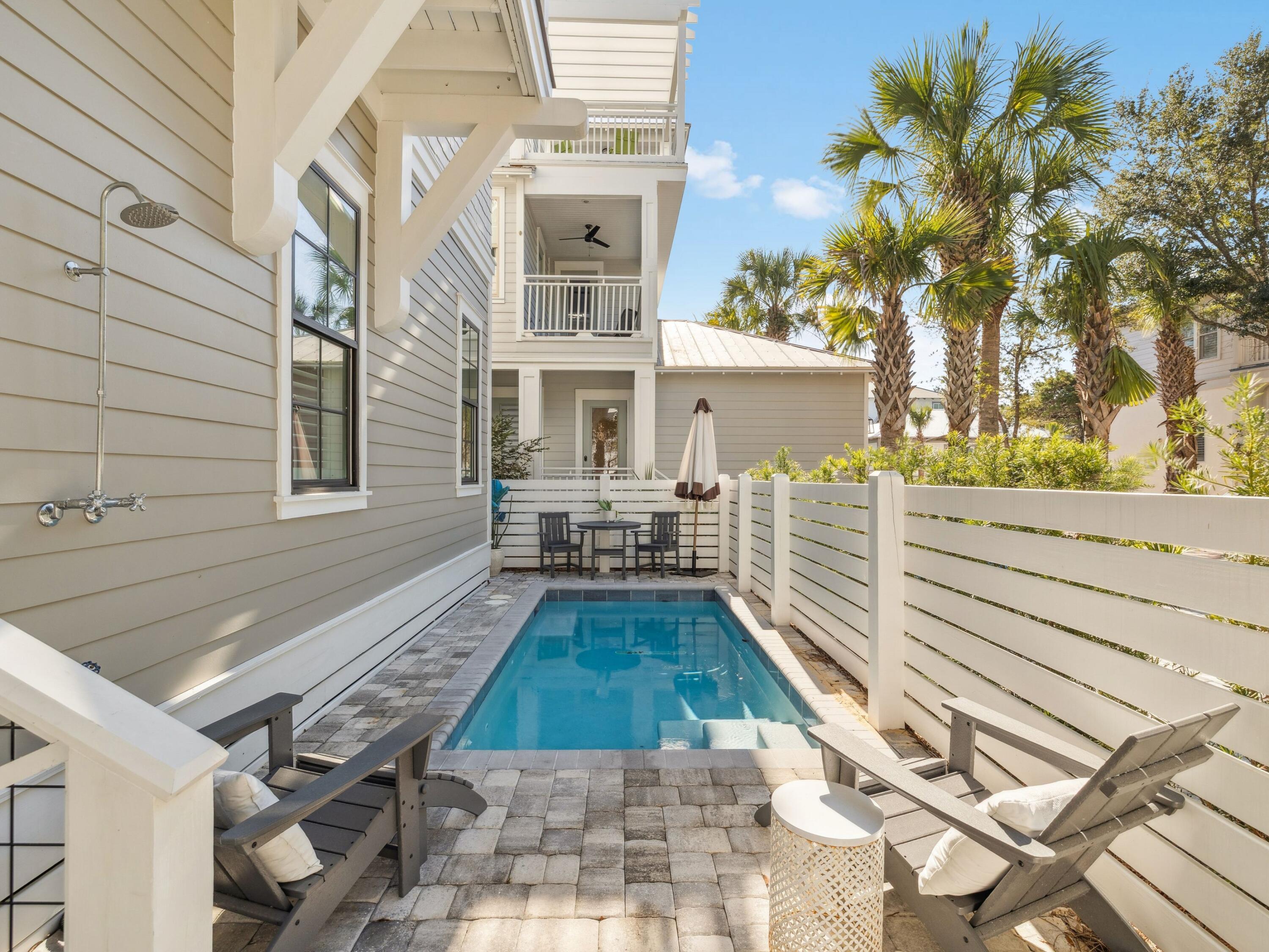 205 Seacrest Beach Boulevard Seacrest, FL 32461 - Photo 16 of 39 a view of a house with backyard and sitting area
