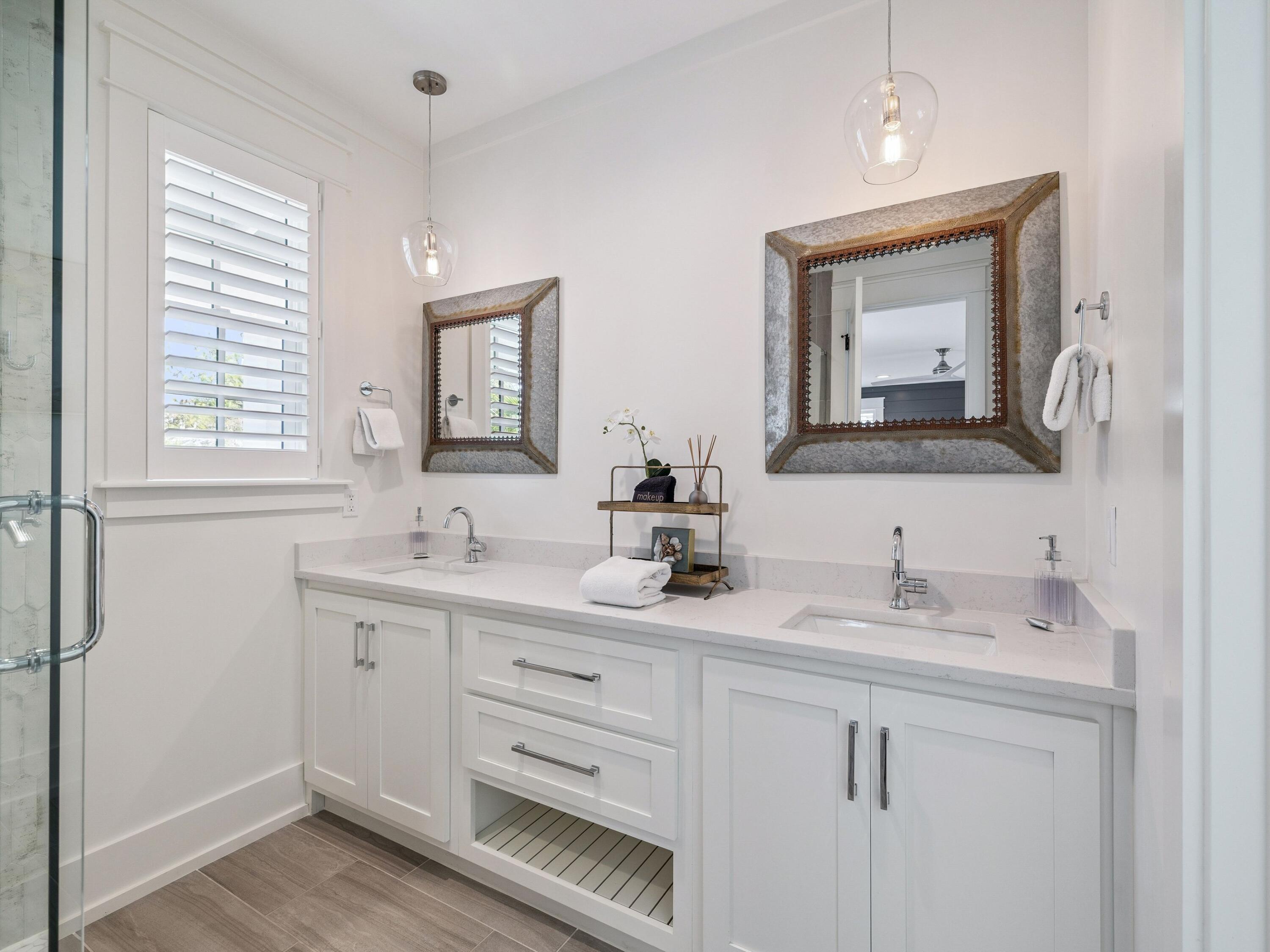 205 Seacrest Beach Boulevard Seacrest, FL 32461 - Photo 21 of 39 a bathroom with double sink and a mirror