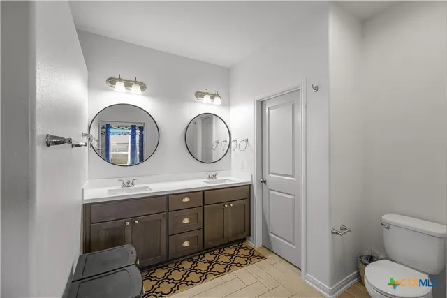 a bathroom with a toilet a sink and a mirror